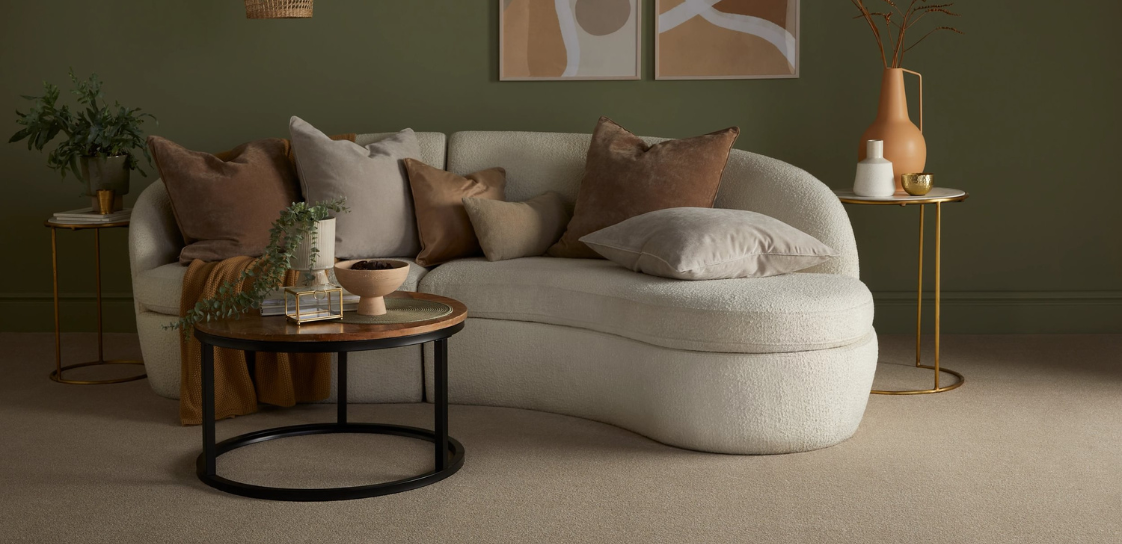 A neutral sititing room with hints of gold and sage