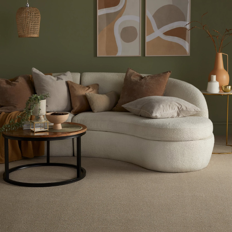 A neutral sititing room with hints of gold and sage